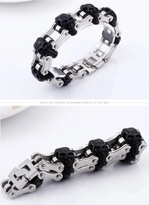 Macro detail of punk pirate skull links on a vintage stainless steel chain bracelet