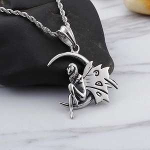 Polished silver stainless steel crescent moon and fairy pendant necklace on stone background
