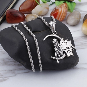 Silver stainless steel moon and angel fairy pendant necklace on a natural stone background