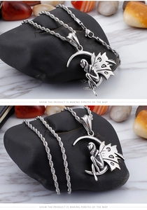 Detail shot of vintage stainless steel fairy sitting on crescent moon pendant necklace