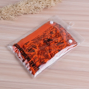 Detail of orange cooling towel with black pattern in hanging plastic zipper pouch