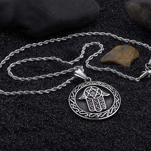 Silver Hand of Fatima and Star of David circular pendant on twisted chain necklace