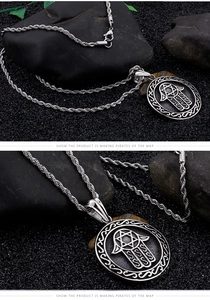 Detailed macro view of silver Hamsa Hand pendant with star on textured stone background