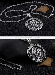 Close-up of silver Hamsa Hand pendant with Star of David on a braided twist chain