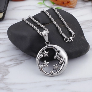 Minimalist silver celestial moon face and stars pendant necklace on textured stone