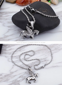 Detailed view of stainless steel Pegasus pendant with vintage rope chain on dark stone