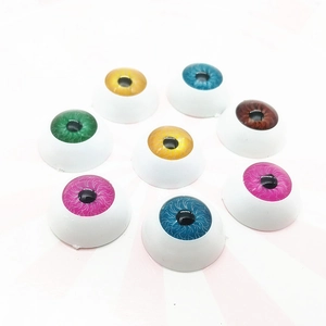 Close-up of 20mm round doll eyes in multiple colors for DIY cream phone case decor