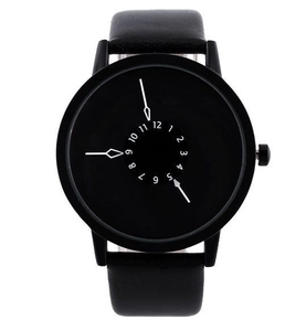Minimalist all-black quartz watch featuring white arrow hands and numeric scale