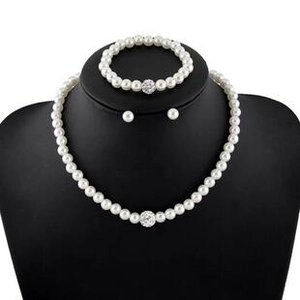 Detailed view of elegant white pearl jewelry set with sparkling pavé crystal spheres