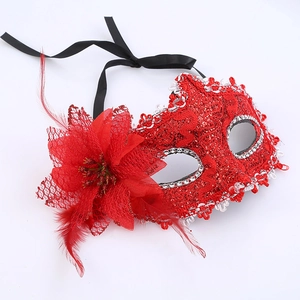 Detailed view of red lace mask with delicate feathers, mesh flowers and shiny sequins