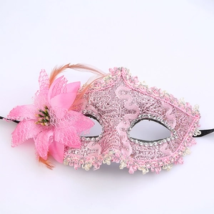 Detail of pink lace party mask with rhinestones, flowers and soft feather embellishments