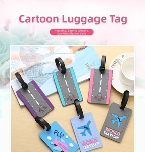 Close-up of colorful PVC luggage tags with airplane and FLY motifs on wooden desk