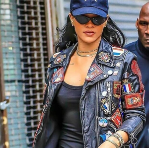 Close-up of vintage cat-eye sunglasses worn with a multi-patch leather biker jacket