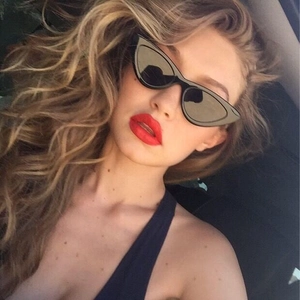 Close-up of vintage black triangle cat eye sunglasses worn by a woman for a chic street look