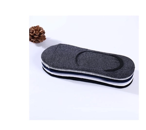 Détail de chaussettes invisibles en coton empilées en gris, blanc et bleu marine