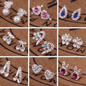 Collection of nine elegant stud earrings featuring crystals, pearls, and flower designs