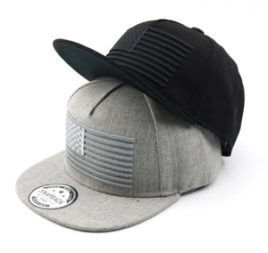 Detail of snapback caps featuring textured US flag embroidery in black and grey cotton