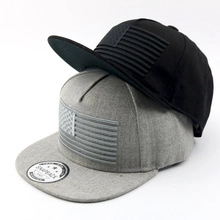 Stacked grey and black snapback hats featuring embossed American flag on the front