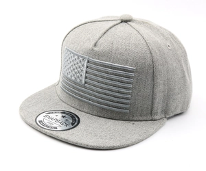 Detail of grey snapback cap with embroidered flag and authentic sticker on flat brim