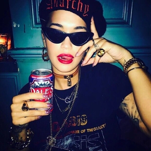 Close-up of retro black cat-eye sunglasses and punk style embroidered beret set