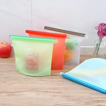 Kitchen scene showing four colorful collapsible silicone funnels on a wood surface