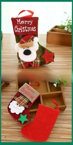 Detail of Christmas stocking ornaments featuring bear and Santa embroidery on wood