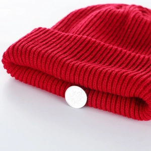 Winter thick red knitted beanie hat for women featuring a stylish rolled cuff design