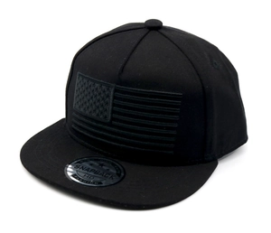 Close-up of black snapback hat with 3D embroidered flag and premium cotton twill texture