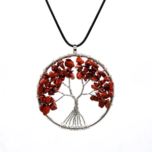 Detailed craftsmanship of handmade tree of life necklace with red agate and silver wire