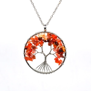 Detailed view of silver tree of life pendant with vibrant carnelian gemstone chips