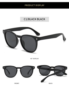 Detail view showing black oval polarized sunglasses with silver metal accents and glossy frame