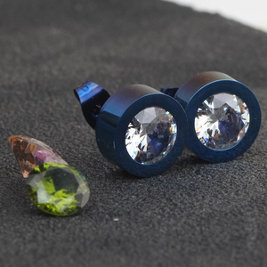 Macro shot of 11mm blue stainless steel earrings with sparkling white cubic zirconia