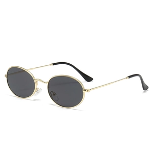 Retro oval punk sunglasses with thin gold metal frame and dark lenses on white background
