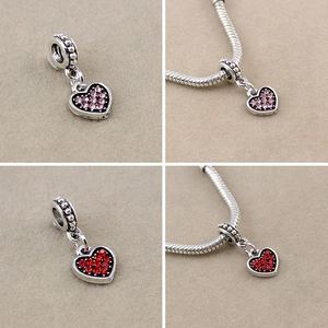 Detailed view of pink and red heart-shaped crystal charms for DIY beaded bracelets