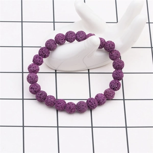 Detail of 8mm purple lava stone beaded bracelet on white ceramic hand model display