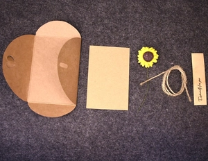 Detail of DIY kraft greeting card with paper sunflower, jute rope and heart-shaped envelope