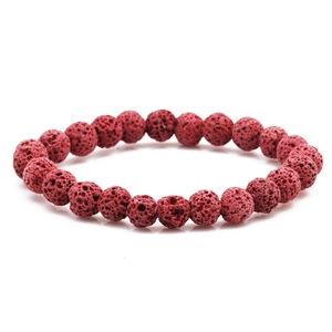Macro shot of 8mm red lava stone beads with natural porous texture on elastic bracelet