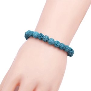 Detail of 8mm blue volcanic lava stone beaded bracelet worn on wrist for casual style