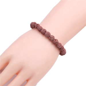 Detailed view of 8mm reddish-brown lava stone beads with natural porous texture on a wrist