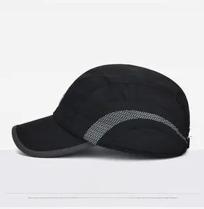 Side view of black winter baseball cap with reflective gray dot patterns and ear protection