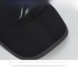 Close-up of black winter baseball cap brim with grey embroidery and reinforced stitching