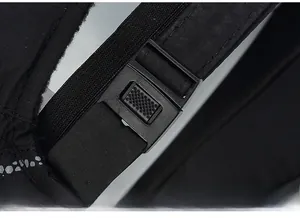 Detail of adjustable strap buckle on black winter baseball cap for custom fit sizing