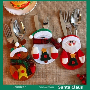 Close-up of felt Christmas cutlery holders featuring reindeer, snowman, and Santa patterns