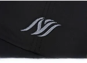 Close-up of grey embroidered logo detail on black winter baseball cap fabric