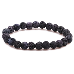 Macro detail of 8mm black volcanic lava stone beads showing natural porous texture