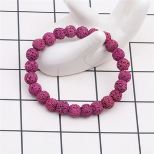 Detail of 8mm purple lava rock beaded bracelet shown on a white ceramic hand model