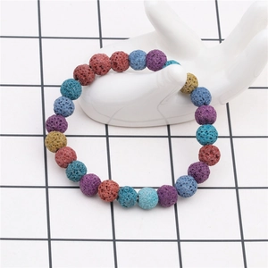 Macro view of 8mm multicolored volcanic lava rock stone beads on an elastic bracelet