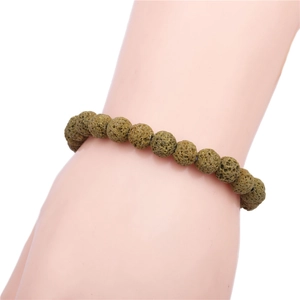 Detailed view of 8mm brown lava stone beaded bracelet on model wrist with white background