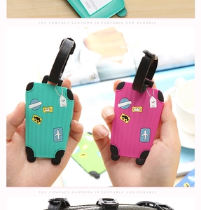 Close-up of PVC luggage tags with cartoon suitcase design and name ID information card