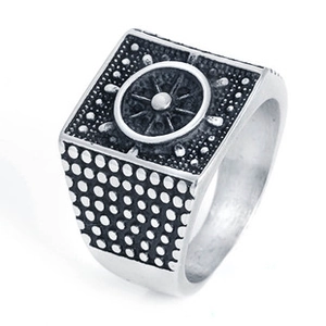 Close-up of vintage titanium steel ring featuring a detailed nautical ship wheel design